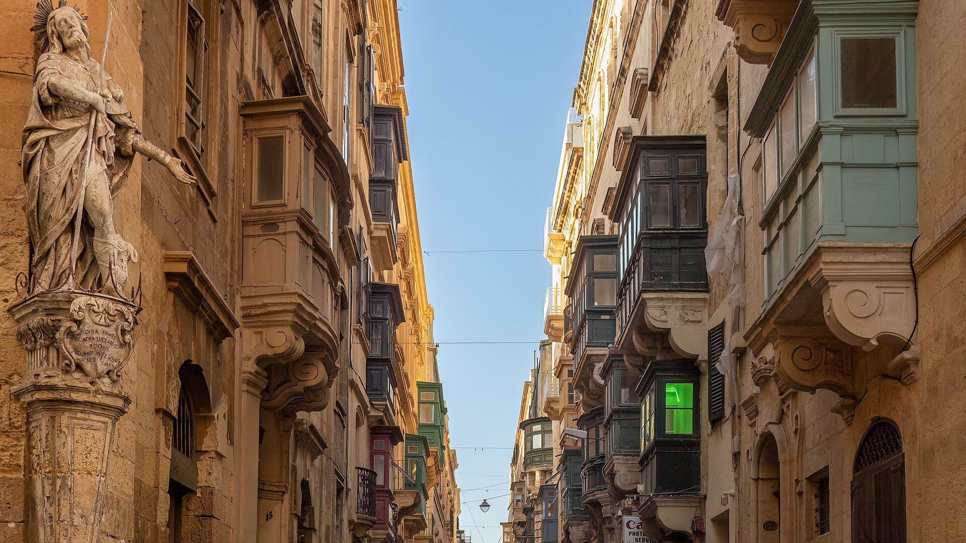 Traditional wooden balconies along a street in Valletta, Malta